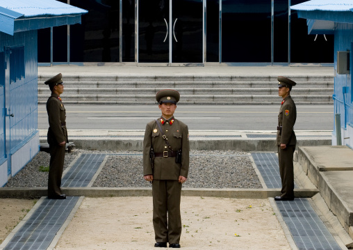 North Korean soldiers standing in front of the United Nations conference rooms on the demarcation line in the Demilitarized Zone, North Hwanghae Province, Panmunjom, North Korea