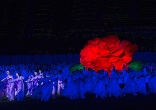 North Korean women dancing in front of a giant Kimilsungia flower during the Arirang mass games in may day stadium, Pyongan Province, Pyongyang, North Korea