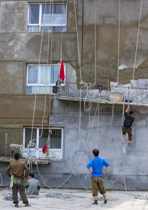 North Korean workmen on a dangerous scaffolding, South Hamgyong Province, Hamhung, North Korea