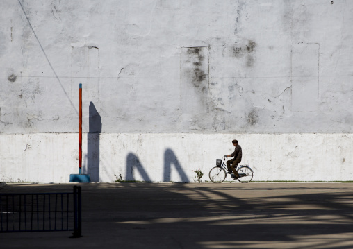 North Korean man riding a bicycle in Hungnam nitrogen fertilizer plant, South Hamgyong Province, Hamhung, North Korea