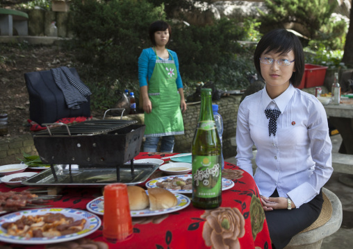 North Korean woman enjoying a picnic in a park on a sunday, Pyongan Province, Pyongyang, North Korea