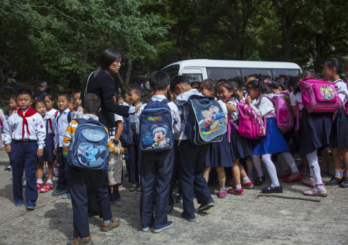 North Korean children with Mickey bags on their backs taking a bus, Pyongan Province, Pyongyang, North Korea