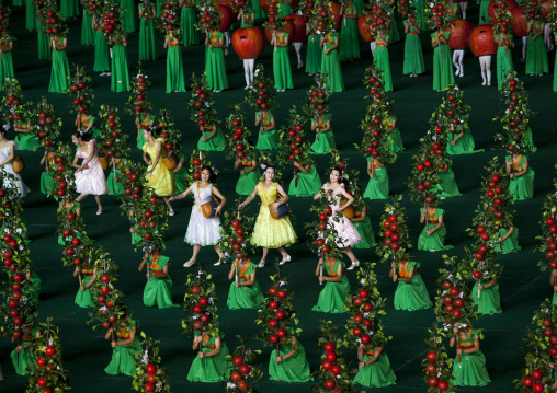 North Korean women dancing between apples during the Arirang mass games in may day stadium, Pyongan Province, Pyongyang, North Korea