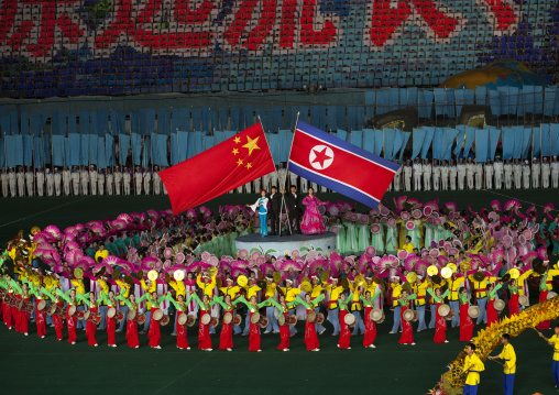 North Korean and chinese flags during the Arirang mass games in may day stadium, Pyongan Province, Pyongyang, North Korea