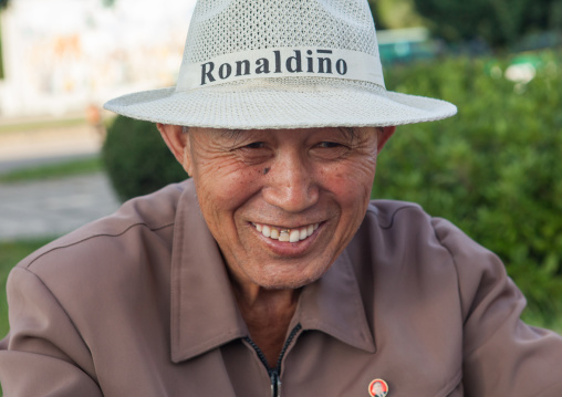 Portrait of a smiling North Korean man with a ronaldino hat, Pyongan Province, Pyongyang, North Korea