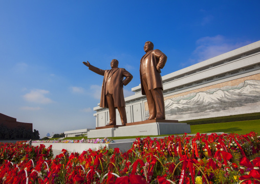 Baskets of flowers in front of the two statues of the Dear Leaders in the Grand monument on Mansu hill, Pyongan Province, Pyongyang, North Korea