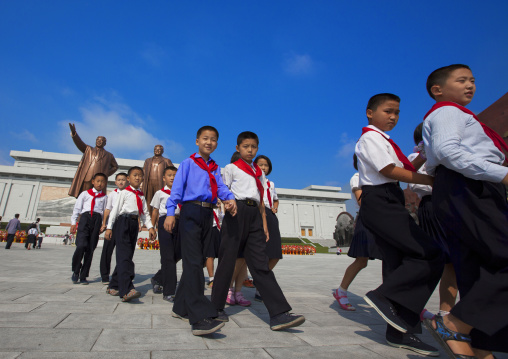 North Korean pioneers from the Korean children's union paying respect to the two statues of the Dear Leaders in the Grand monument on Mansu hill, Pyongan Province, Pyongyang, North Korea