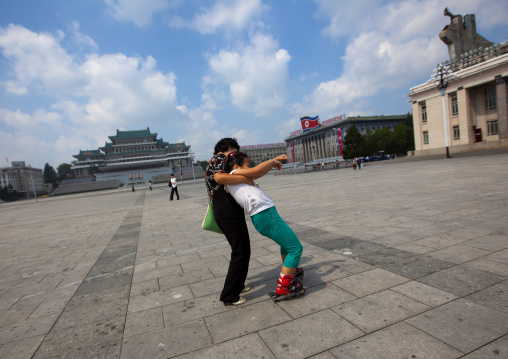 North Korean girl learning to roller stake with her mother in Kim il Sung square, Pyongan Province, Pyongyang, North Korea