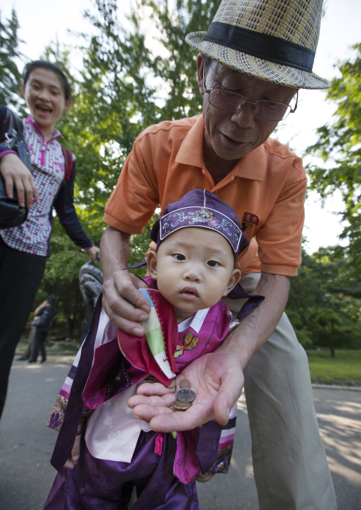 Portrait of a North Korean Grand father with his little one year old son, Pyongan Province, Pyongyang, North Korea