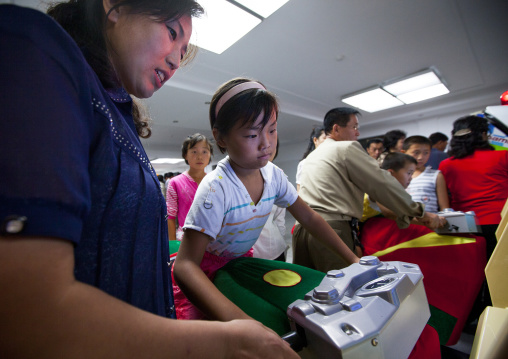 North Korean girl on a motorbike simulator in Kaeson youth park, Pyongan Province, Pyongyang, North Korea