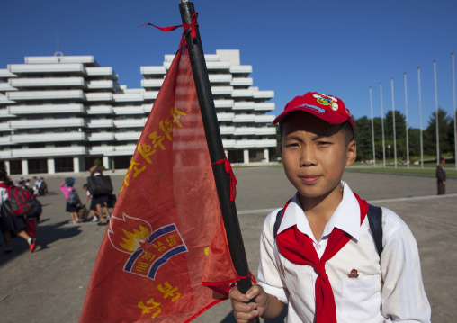 North Korean pioneer holding a flag in Songdowon international children's camp, Kangwon Province, Wonsan, North Korea