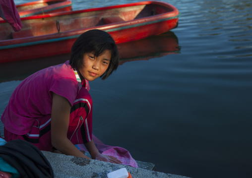 North Korean girl washing her clothes in the lake of the Songdowon international children's camp, Kangwon Province, Wonsan, North Korea