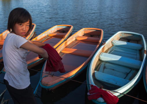 North Korean girl washing her clothes in the lake of the Songdowon international children's camp, Kangwon Province, Wonsan, North Korea