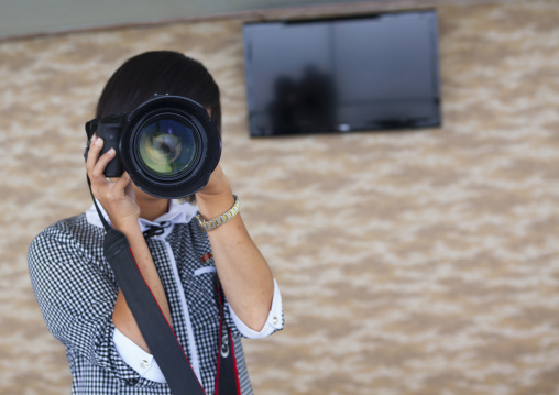 North Korean woman testing a professional camera, Pyongan Province, Pyongyang, North Korea