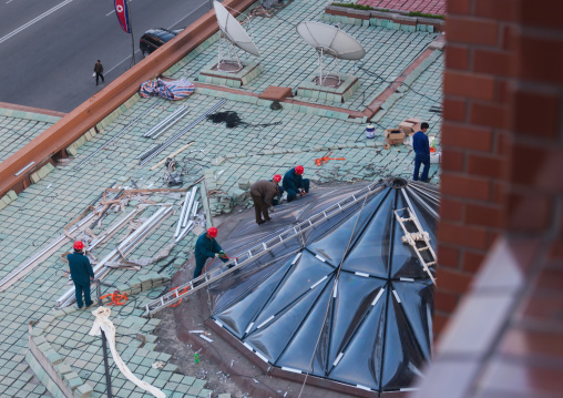 North Korean workers repairing a roof Koryo hotel, Pyongan Province, Pyongyang, North Korea