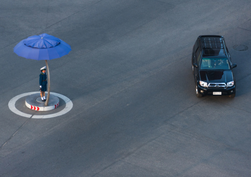 North Korean traffic security officer in blue uniform in the street, Pyongan Province, Pyongyang, North Korea