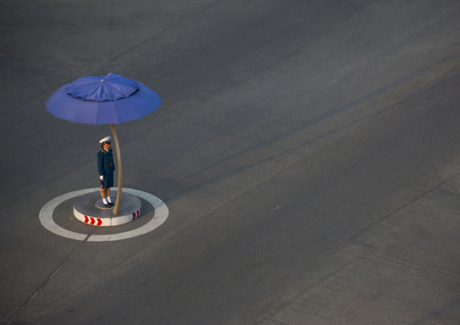 North Korean traffic security officer in blue uniform in the street, Pyongan Province, Pyongyang, North Korea