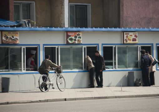 North Korean people byuing food in fast food shops in the city center, Pyongan Province, Pyongyang, North Korea