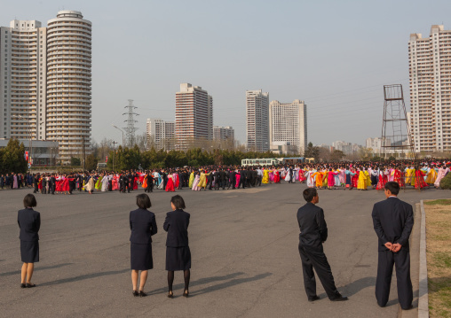 North Korean young adults during a mass dance performance in front of buildings on military foundation day, Pyongan Province, Pyongyang, North Korea