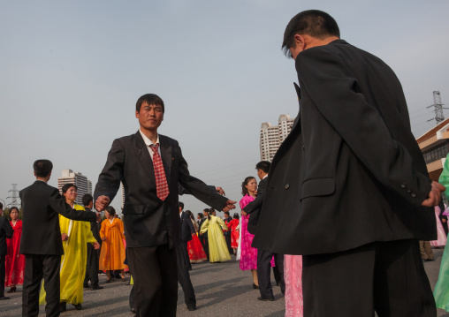 North Korean young adults during a mass dance performance in front of buildings on military foundation day, Pyongan Province, Pyongyang, North Korea