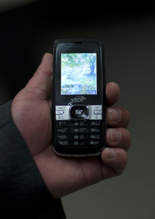 North Korean man holding a koryolink mobile phone, Pyongan Province, Pyongyang, North Korea