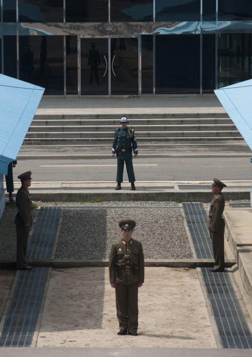 North Korean soldiers standing in front of the United Nations conference rooms on the demarcation line in the Demilitarized Zone, North Hwanghae Province, Panmunjom, North Korea