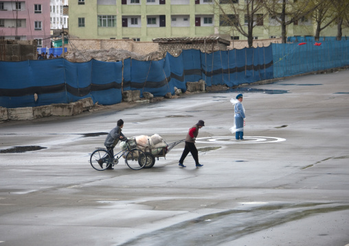 North Korean male traffic security officer in blue uniform under the rain, North Hwanghae Province, Kaesong, North Korea