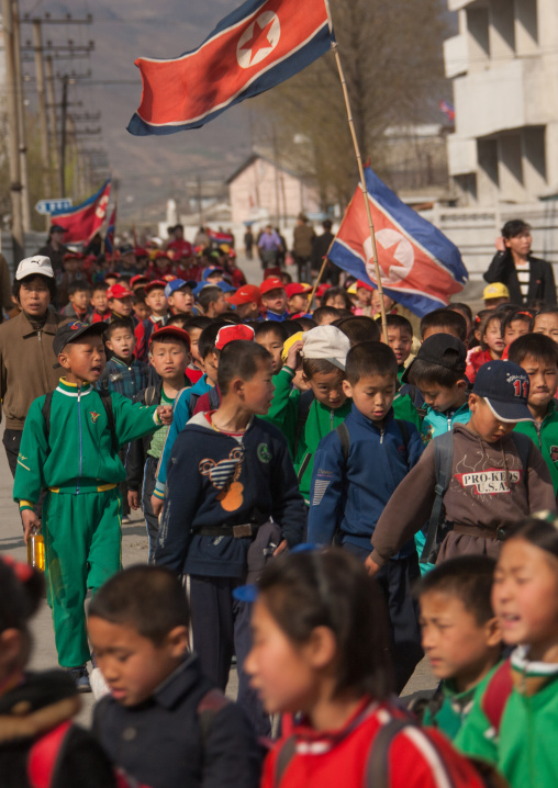 North Korean children parading in the streets on the international workers' day with the national flag, Kangwon Province, Wonsan, North Korea