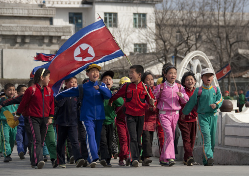 North Korean children parading in the streets on the international workers' day with the national flag, Kangwon Province, Wonsan, North Korea