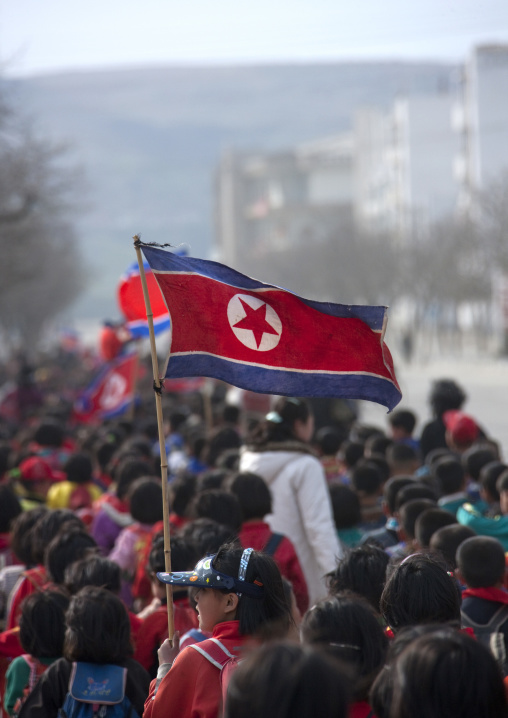 North Korean children parading in the streets on the international workers' day with the national flag, Kangwon Province, Wonsan, North Korea