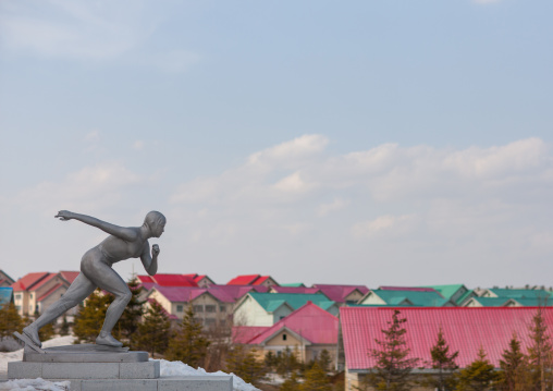 Statue of a ice skaters in front of new apartment houses, Ryanggang Province, Samjiyon, North Korea