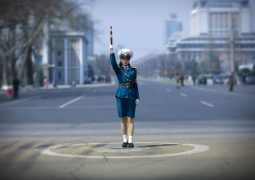 North Korean traffic security officer in blue uniform in the street, Pyongan Province, Pyongyang, North Korea