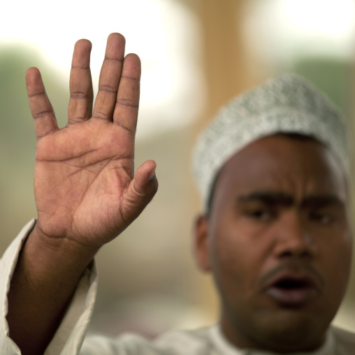 Man Waving Hand In Nizwa Cattle Market, Nizwa, Oman