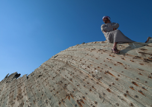 Man Sitting On The Wreck Of Dhow And Looking Proudly, Masirah Island, Oman