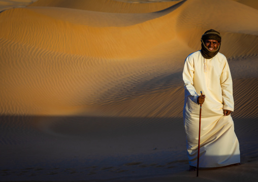 Omani man walking in the rub al khali desert, Dhofar Governorate, Rub al Khali, Oman