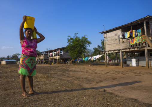 Panama, Darien Province, Alto Playona, Woman Of The Native Indian Embera Tribe Carrying Water On The Head