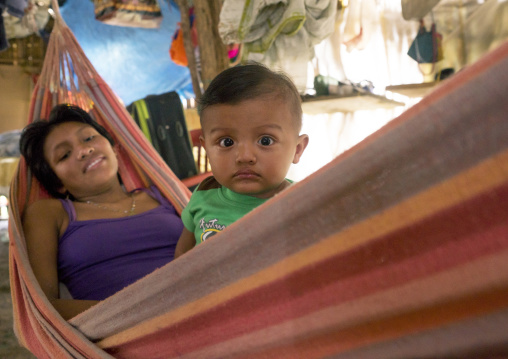 Panama, San Blas Islands, Mamitupu, Portrait Of A Kuna Tribe Mother With Her Baby In A Hammock