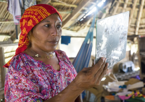 Panama, San Blas Islands, Mamitupu, Gay Kuna Indigenous Man Wearing Female Traditional Clothes Looking At Himself In A Miror