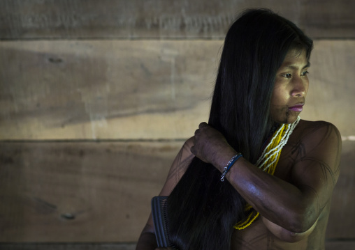 Panama, Darien Province, Bajo Chiquito, Woman Of The Native Indian Embera Tribe Combing Hair