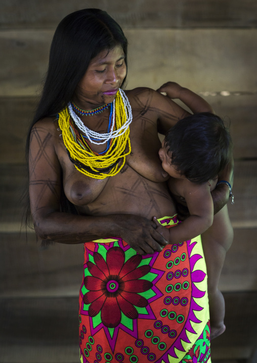 Panama, Darien Province, Bajo Chiquito, Woman Of The Native Indian Embera Tribe Breastfeeding Her Baby