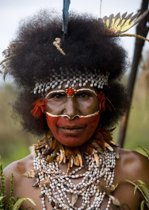 Papuan woman with red tribal makeup on the face, Western Highlands Province, Mount Hagen, Papua New Guinea