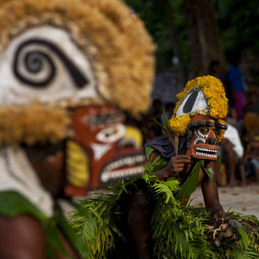 Malagan tatuana masks dance during a funeral ceremony, New Ireland Province, Langania, Papua New Guinea