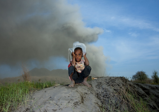 Boy under a volcanic eruption in tavurvur volcano, East New Britain Province, Rabaul, Papua New Guinea