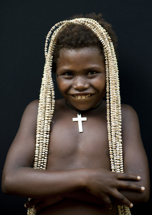 Girl holding a giant shell money, East New Britain Province, Rabaul, Papua New Guinea