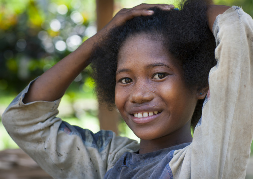 Portrait of a young girl smiling, Milne Bay Province, Trobriand Island, Papua New Guinea