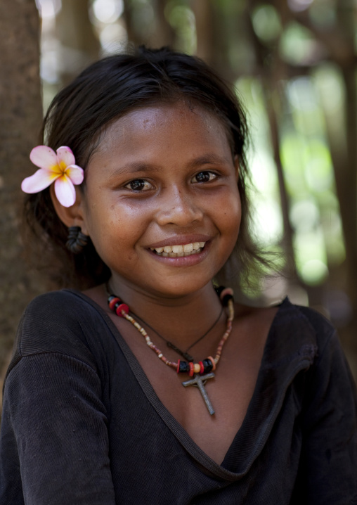 Smiling girl with flowers in the hair, Milne Bay Province, Trobriand Island, Papua New Guinea