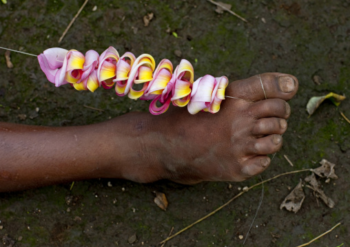 Girl making a flower crown, Milne Bay Province, Trobriand Island, Papua New Guinea