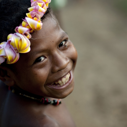 Smiling girl with flowers in the hair, Milne Bay Province, Trobriand Island, Papua New Guinea