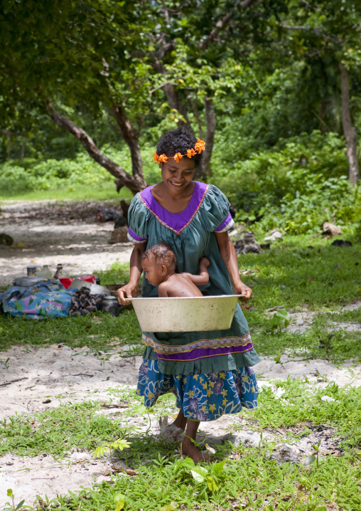 Mother and child having a bath, Milne Bay Province, Trobriand Island, Papua New Guinea