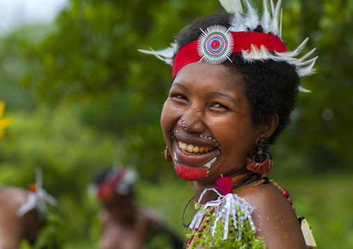 Portrait of a smiling tribal woman in traditional clothing, Milne Bay Province, Trobriand Island, Papua New Guinea